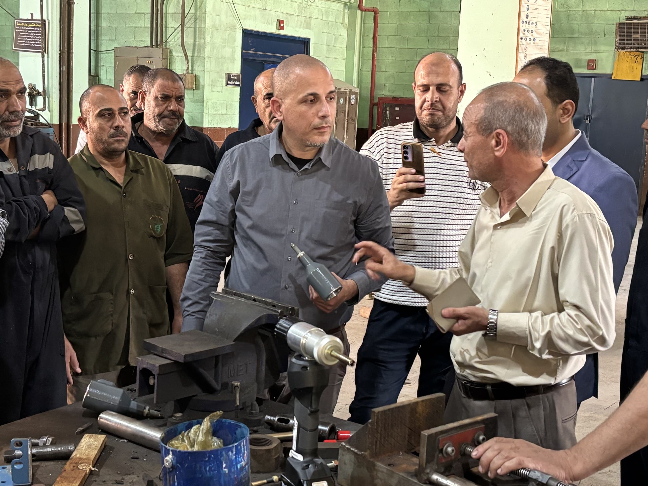 Plant technicians handling EST tube plugging tools during the hands-on workshop